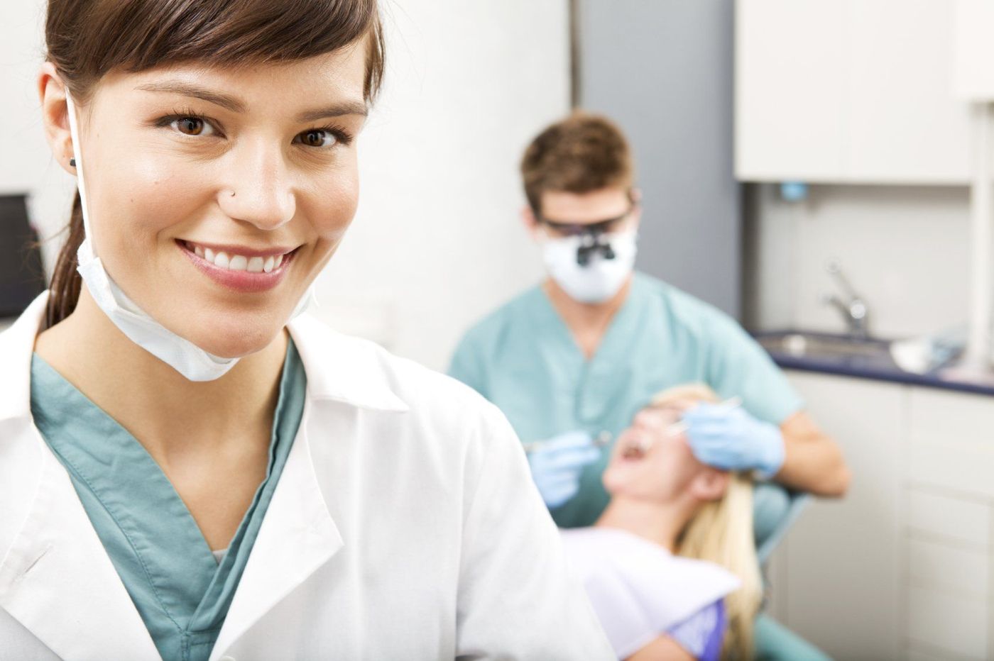 Smiling dental professional in a bright treatment room